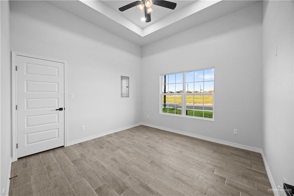 3409 Tyler Street Mission, TX 78572 - Photo 11 of 14 an empty room with a window and a ceiling fan