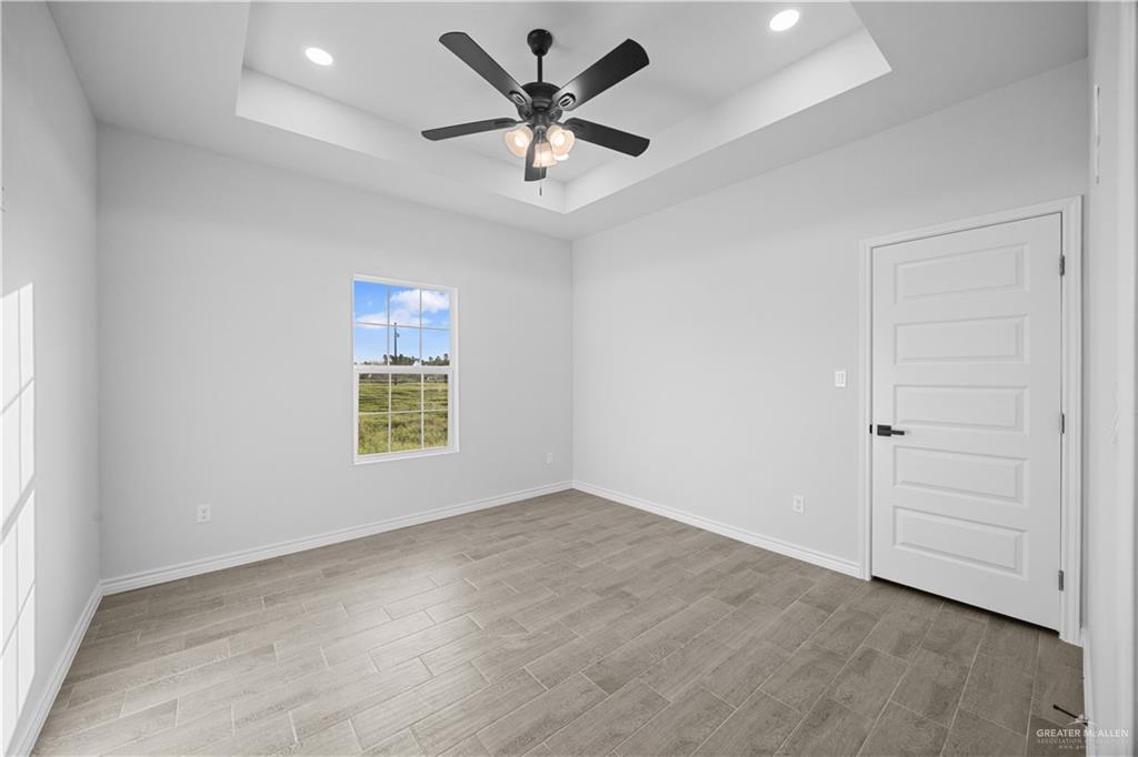 3409 Tyler Street Mission, TX 78572 - Photo 12 of 14 wooden floor in an empty room with a window
