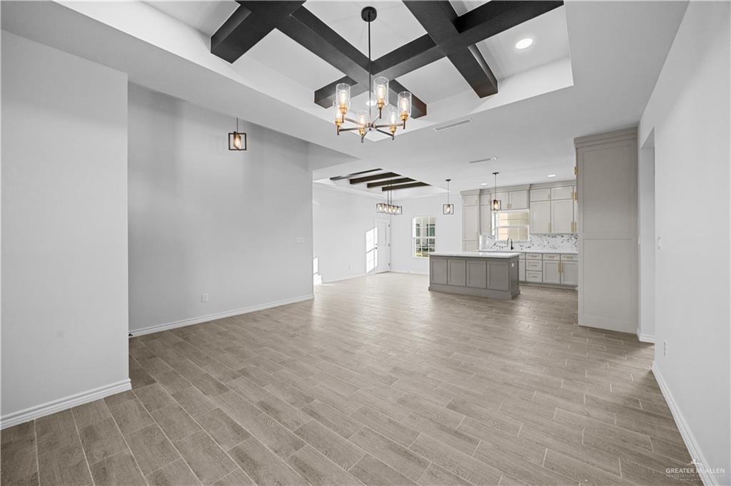 3409 Tyler Street Mission, TX 78572 - Photo 3 of 14 an empty room with wooden floor ceiling fan and windows