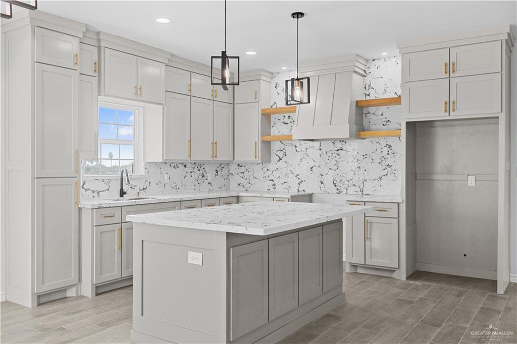 3409 Tyler Street Mission, TX 78572 - Photo 4 of 14 a kitchen with kitchen island white cabinets sink and refrigerator