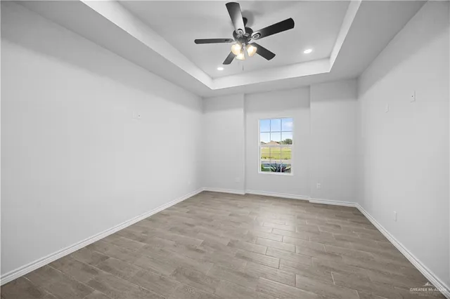 a bathroom with a granite countertop sink toilet and mirror