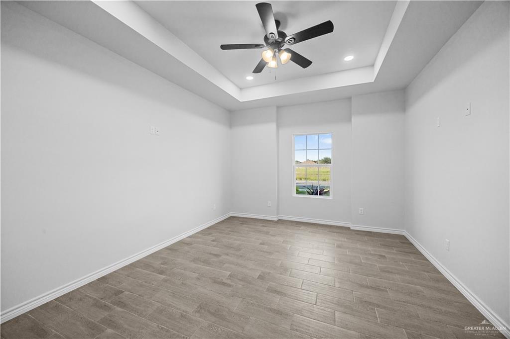 3409 Tyler Street Mission, TX 78572 - Photo 7 of 14 wooden floor in an empty room with a window