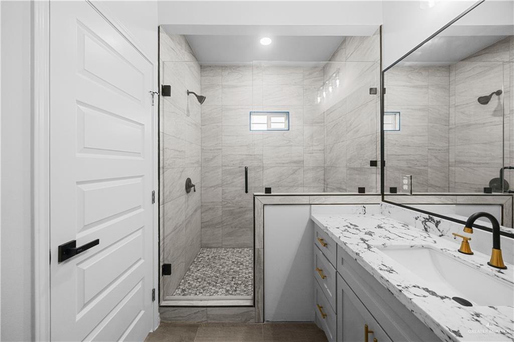 3409 Tyler Street Mission, TX 78572 - Photo 9 of 14 a bathroom with a sink and a shower