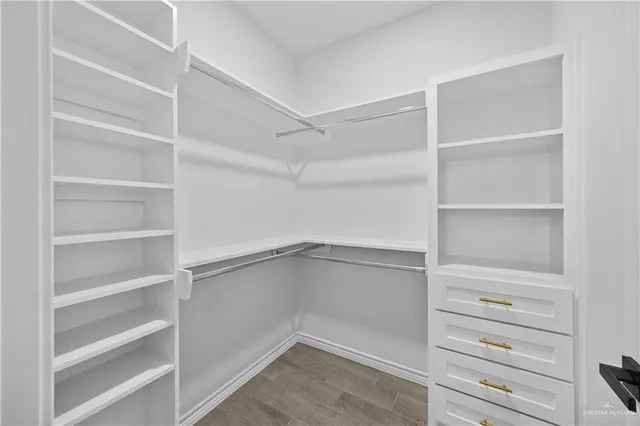 an empty room with a window and a ceiling fan