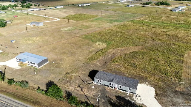 an aerial view of residential houses with outdoor space