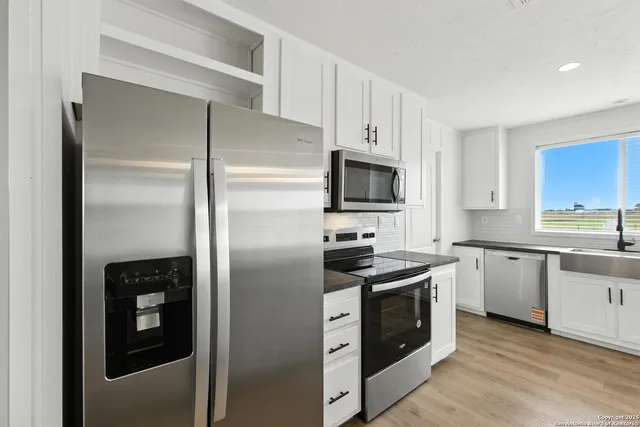 a kitchen with a refrigerator stove and sink