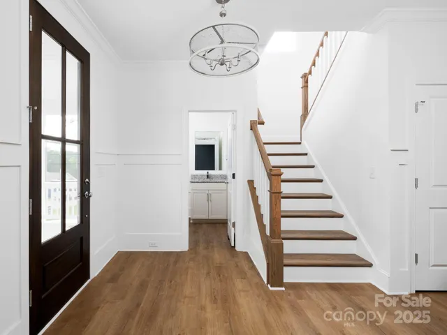 a view of a hallway with wooden floor and entryway
