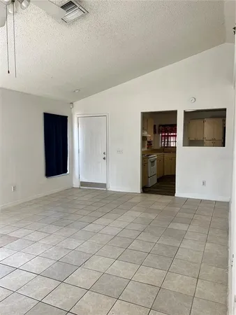 a view of a livingroom with a dishwasher and cabinets