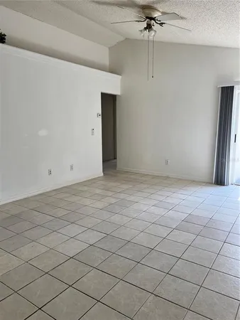 an empty room with a ceiling fan