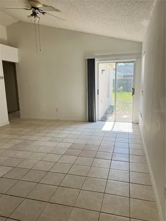 a view of an empty room and a window