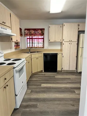 a kitchen with white cabinets and white appliances
