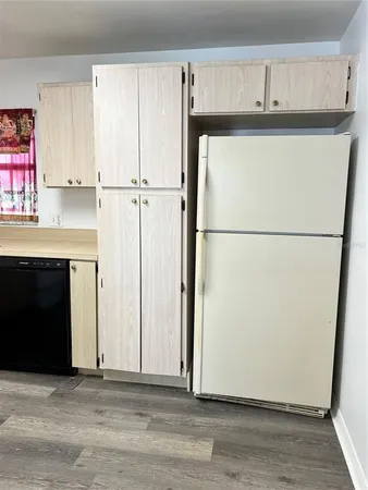 a view of a kitchen with refrigerator and cabinet
