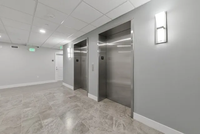 an empty room with windows and closet