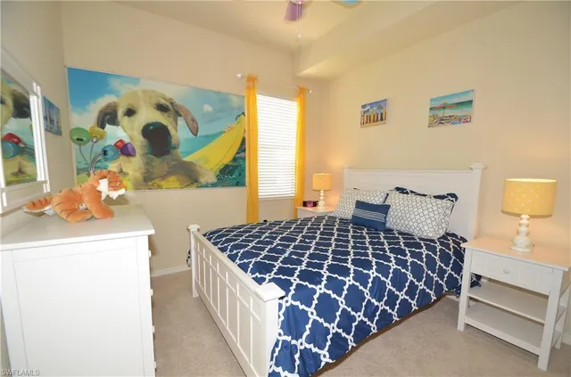 a bedroom with a bed and painting on the wall