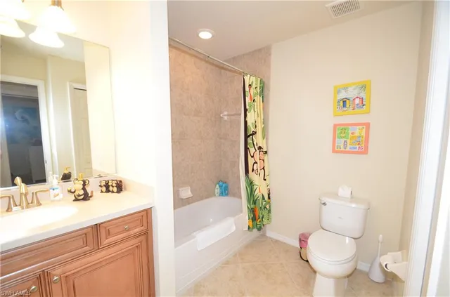 a bathroom with a sink mirror toilet and bathtub