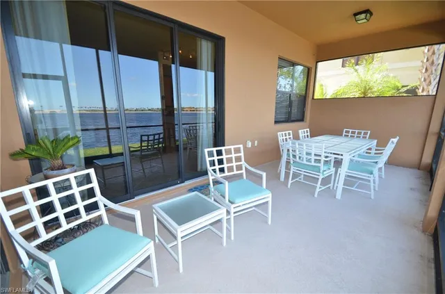 a dining room with furniture and a floor to ceiling window