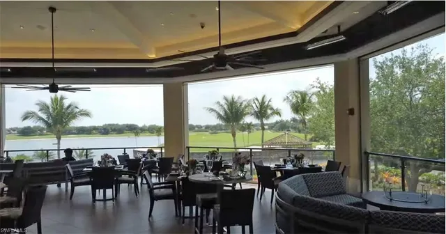 a view of a living room with furniture and floor to ceiling window