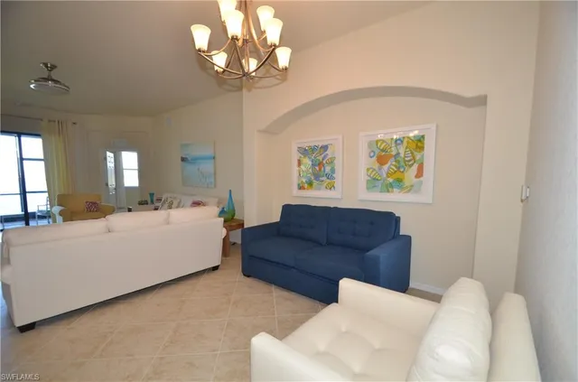 a living room with couches and painting on the wall