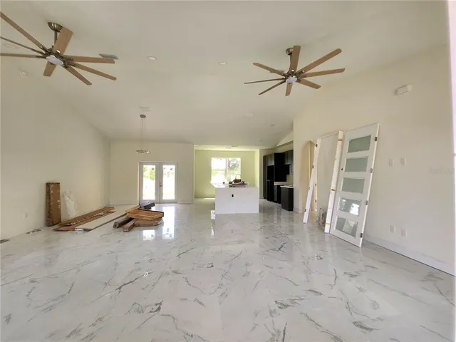 a white house with a big yard and large trees