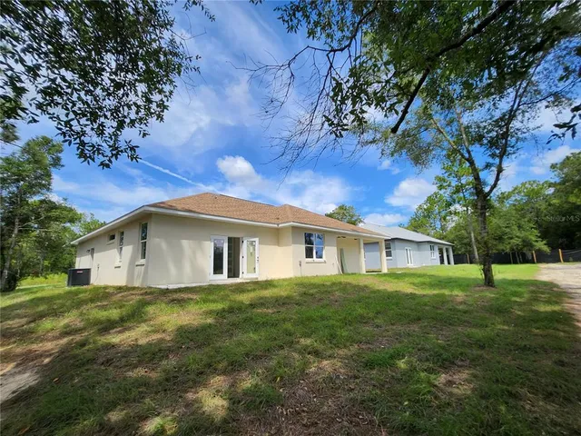 en empty room with windows and fan