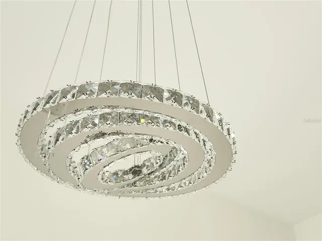 en empty room with windows and ceiling fan