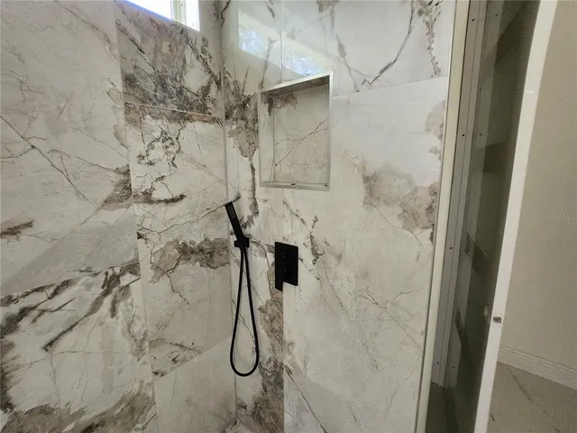 a view of a backyard with chairs and a stove