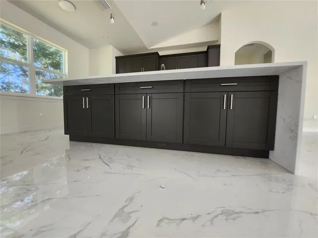 a view of a house with potted plants in front of door