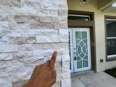 a front view of a house with a garden and yard