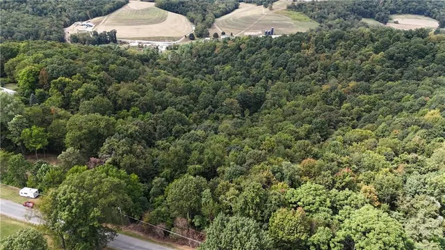 an aerial view of a houses with a yard