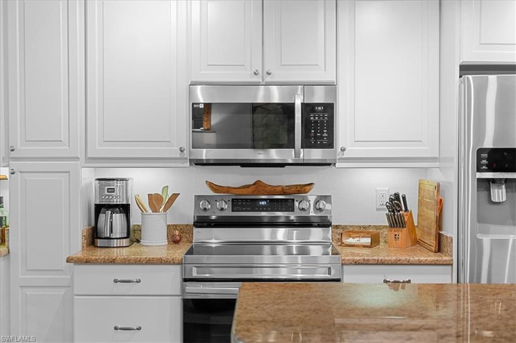 380 4th Avenue South, Unit 380 Naples, FL 34102 - Photo 13 of 19 a kitchen with appliances cabinets and a counter top space
