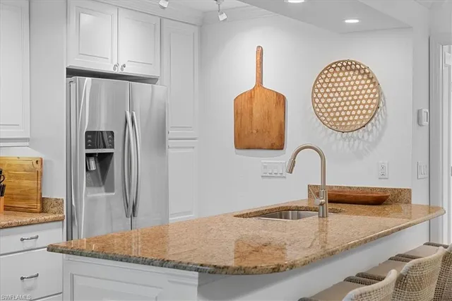 a kitchen with sink and refrigerator
