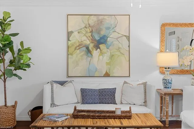 a living room with furniture and a potted plant