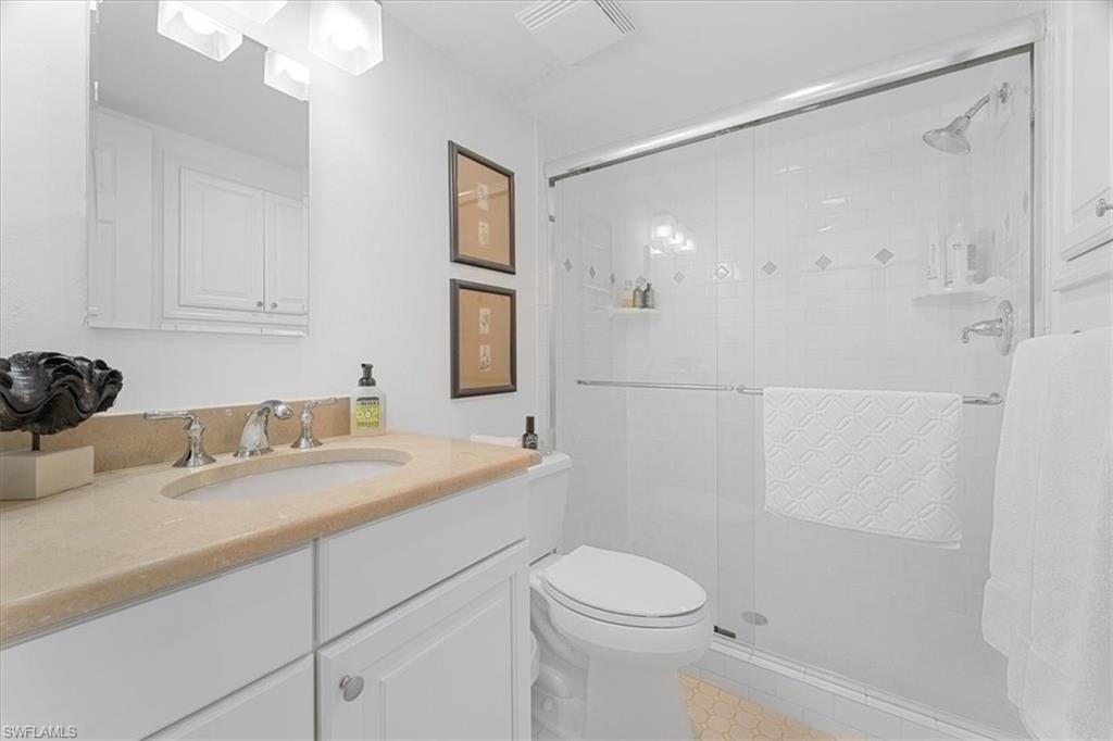 380 4th Avenue South, Unit 380 Naples, FL 34102 - Photo 9 of 19 a bathroom with a sink a toilet and shower