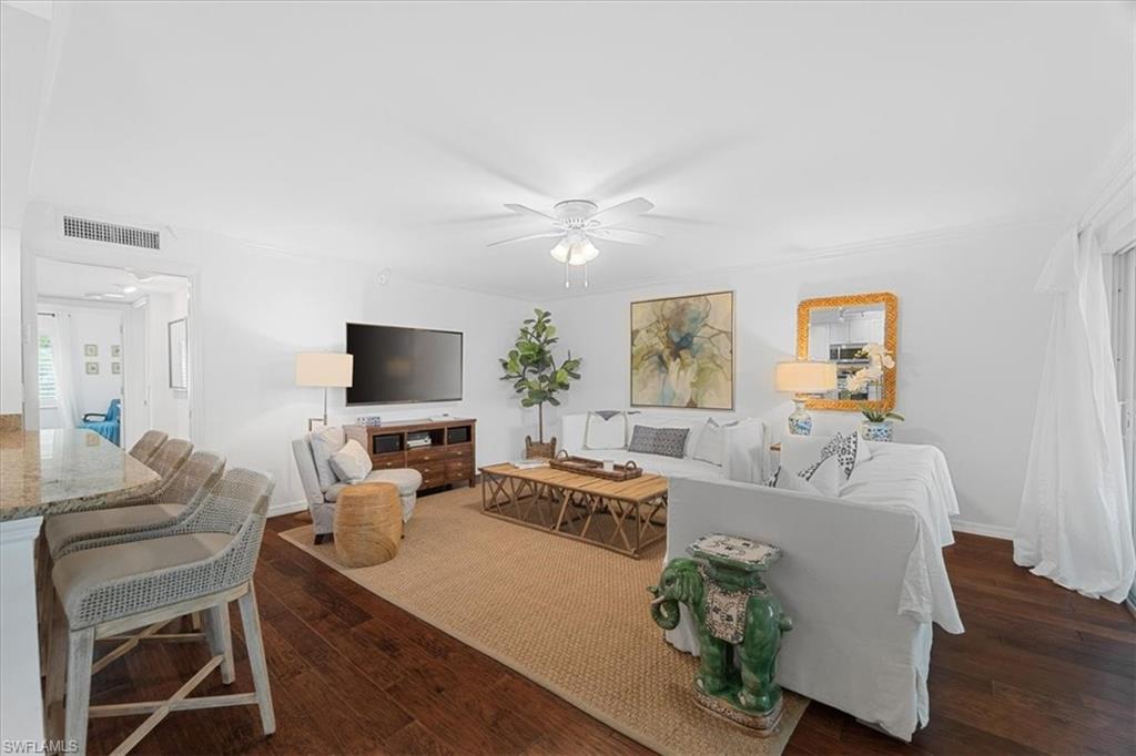 380 4th Avenue South, Unit 380 Naples, FL 34102 - Photo 10 of 19 a living room with furniture a large window and a flat screen tv