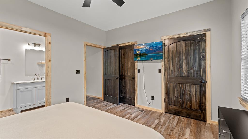 228 Old Factory Road Murfreesboro, AR 71958 - Photo 12 of 37 a bedroom with a bed and a mirror