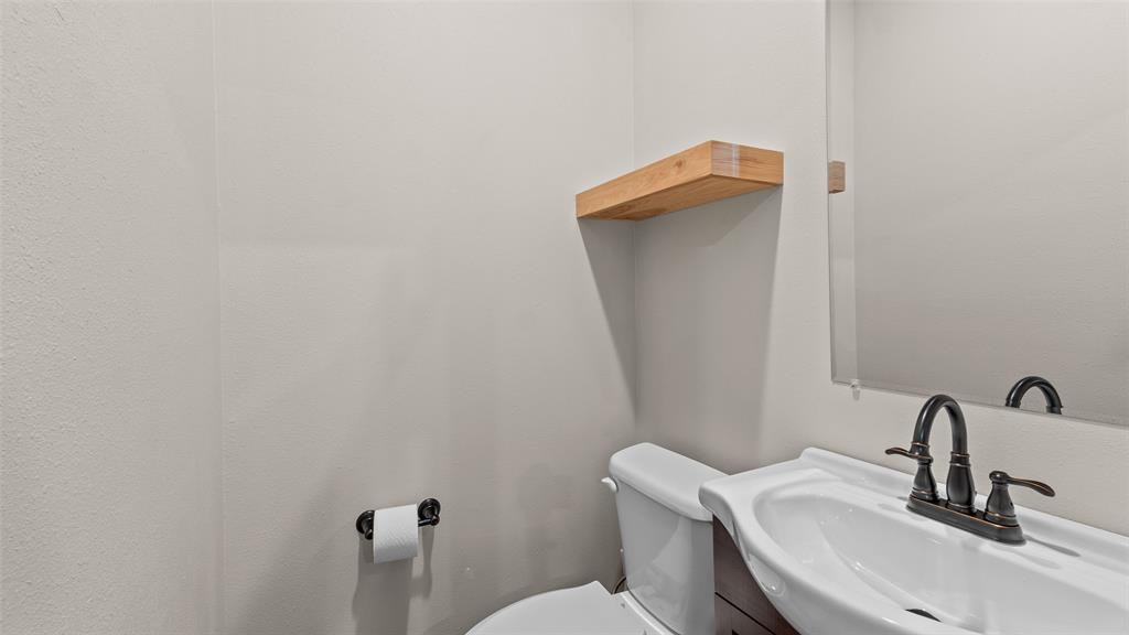 228 Old Factory Road Murfreesboro, AR 71958 - Photo 14 of 37 a bathroom with a sink a toilet and mirror