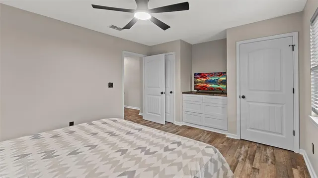 a bedroom with a large bed and a chandelier