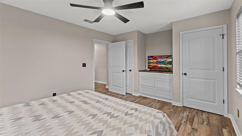 228 Old Factory Road Murfreesboro, AR 71958 - Photo 21 of 37 a bedroom with a large bed and a chandelier