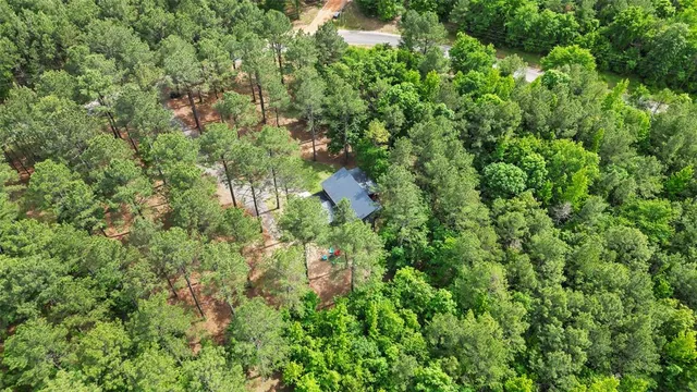 a backyard of a house with lots of trees