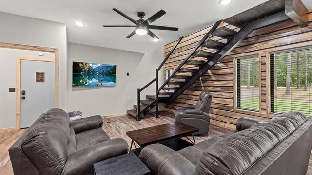 a living room with furniture ceiling fan and a window