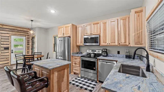 a kitchen with a stove sink and microwave