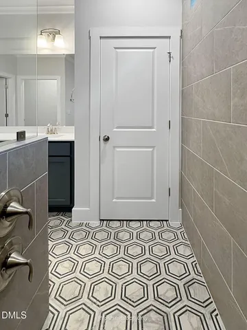 a spacious bedroom with a bed and wooden floor