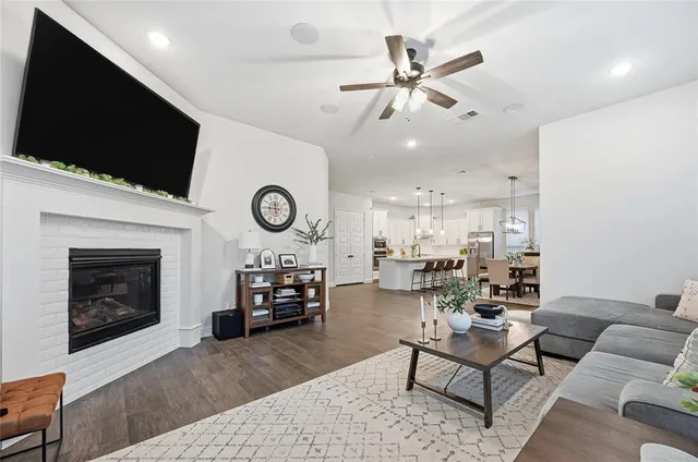 a living room with furniture a fireplace and a flat screen tv