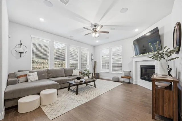 a living room with furniture a fireplace and a flat screen tv