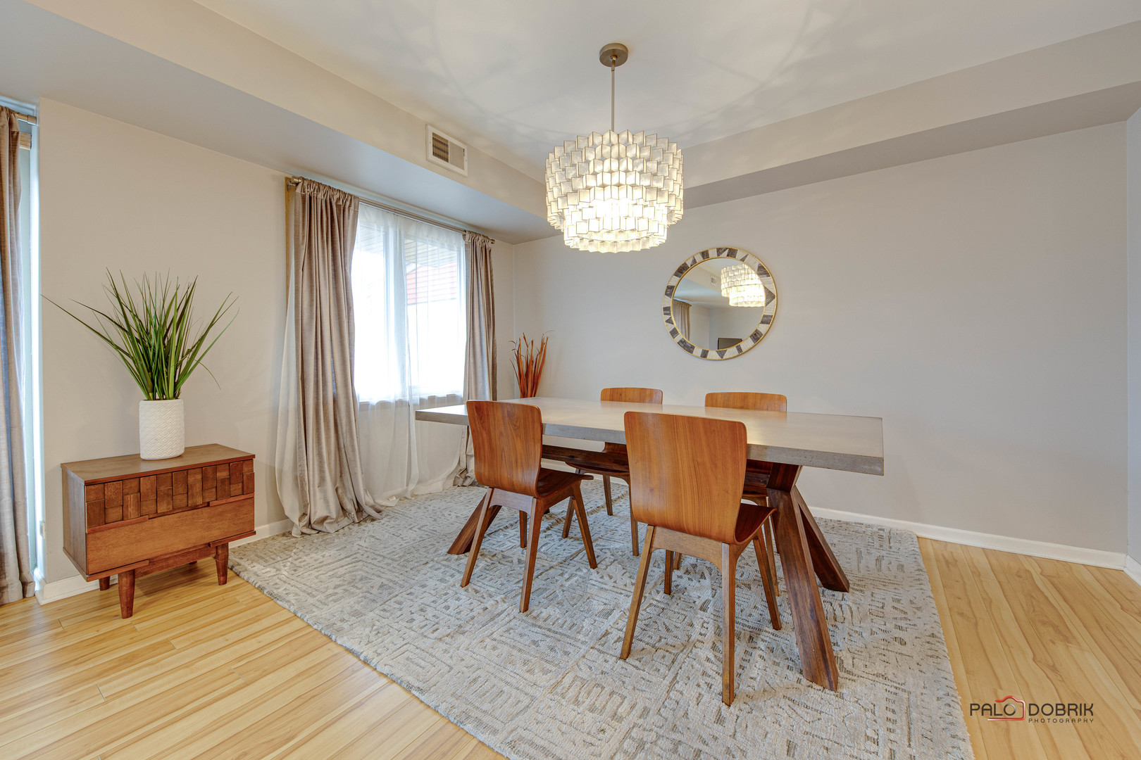 2420 West Talcott Road, Unit 315 Park Ridge, IL 60068 - Photo 12 of 22 a view of a dining room with furniture a chandelier and wooden floor