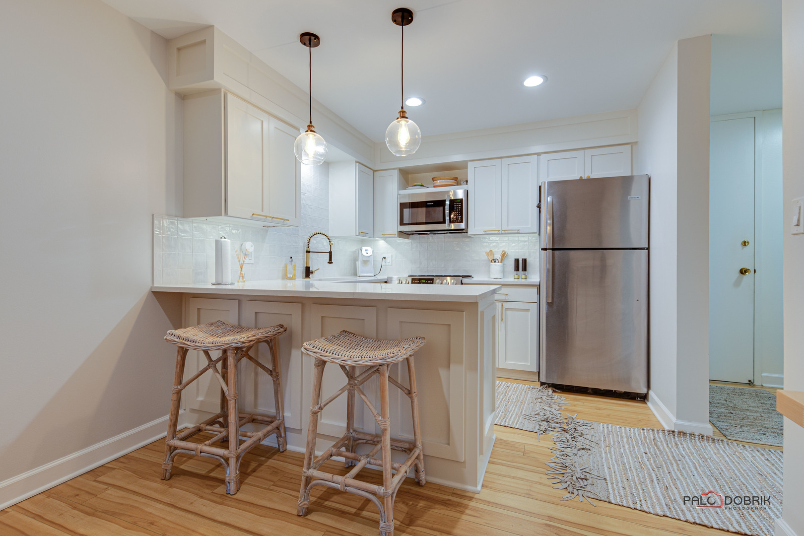 2420 West Talcott Road, Unit 315 Park Ridge, IL 60068 - Photo 9 of 22 a kitchen with kitchen island white cabinets and stainless steel appliances