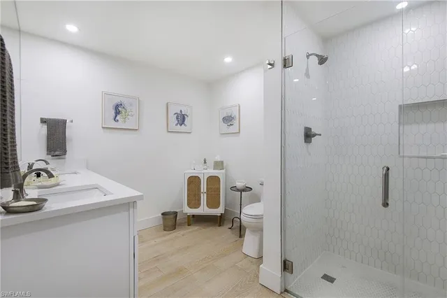 a bathroom with a sink toilet and shower
