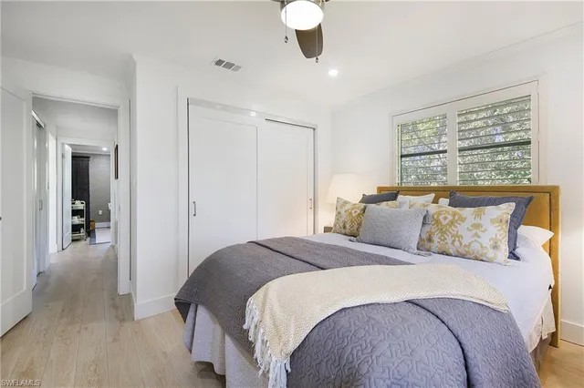 a bedroom with a large bed and a chandelier