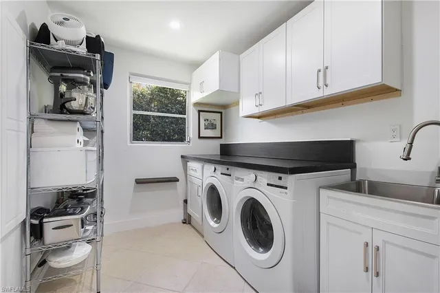 a utility room with sink dryer and washer