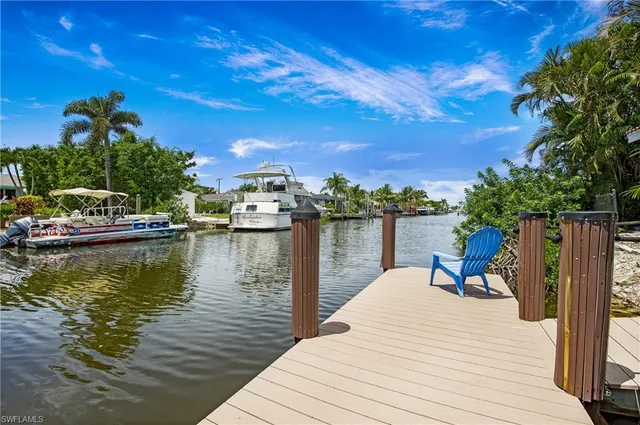 a view of a lake with a table and chairs